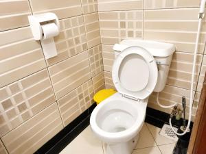 a bathroom with a white toilet in a stall at Mama Maendeleo Resort in Hindi