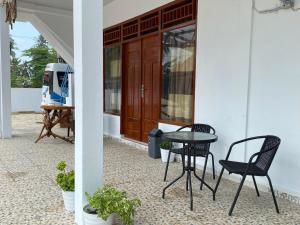 two chairs and a table on a patio at Surak Villa Mentawai in Katiet