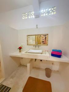 a bathroom with a sink and a mirror at Mepoho Beach Villa Watamu in Watamu +48 photos