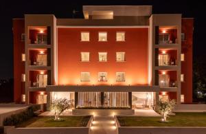 a rendering of a building at night at PALAZZO RUBINO Aparthotel in Olbia