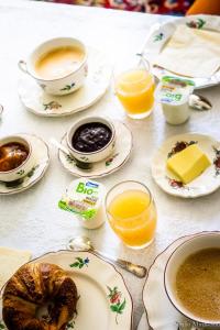 a table topped with cups of coffee and plates of food at Château D'Alteville in Tarquimpol