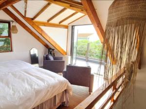 a bedroom with a bed and a large window at Saint Anna Beach House in St. Helena Bay +47 photos