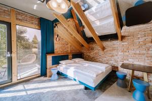 a bedroom with a bed and a brick wall at Apartamenty Wieliczka in Wieliczka