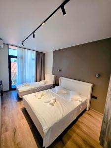 a bedroom with two beds and a large window at ,,KaKalo'' Apartments in Kobuleti +73 photos