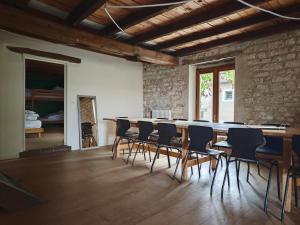 a room with a long table and chairs at Domaine du Moulin Français in Champougny