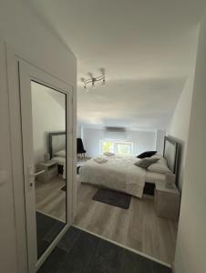 a bedroom with a large bed and a mirror at Storm in Varna City