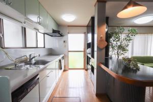 a kitchen with a sink and a counter at 民泊 Vacation rental "Tajimi-jyuku Kitaya" Base for trips to Ghibli Park,Tsumago-juku,Magome-juku in Tajimi +84 photos
