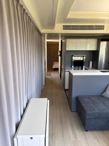 a living room with a couch and a kitchen at Capsule house for rent at Gut Holtmann in Billerbeck