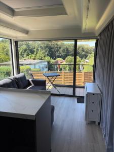 a living room with a couch and a table at Capsule house for rent at Gut Holtmann in Billerbeck