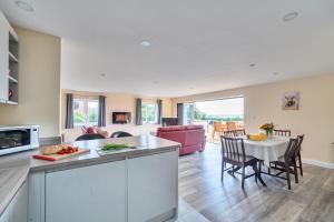 a kitchen and living room with a table and chairs at The Donkey Shed in Sherborne