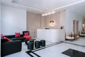 a lobby with a couch and a table and a bar at Horizon Minh Chau Hotel in Quang Ninh