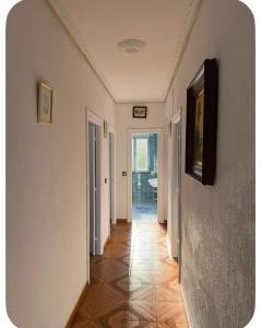 a hallway with white walls and a tile floor at El Rincón de pedreña in Pedreña +7 photos