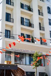 a building with a sign for a hotel at Horizon Minh Chau Hotel in Quang Ninh