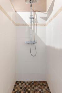 a shower in a white tiled bathroom with a ceiling at KAZUBUNTU in Saint-Leu +28 photos
