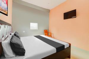 a bedroom with a bed and a tv on the wall at Hotel O Luxury Palace in Malīhābād