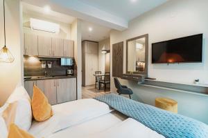 a hotel room with a bed and a kitchen at Amethyst in Sovata
