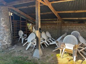 a group of chairs and tables in a building at Maison familiale 10 pers à St Setiers in Saint-Setiers