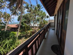 a balcony of a house with a view of the ocean at Ocean Haven in Induruwa