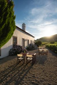 a building with tables and chairs in front of it at Morgadio da Calcada Douro Wine&Tourism in Pinhão