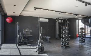 a gym with black walls and exercise equipment at Ancorar Hospedagens in João Pessoa