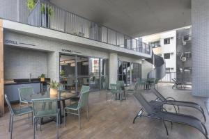 a dining room with a table and chairs in a building at Ancorar Hospedagens in João Pessoa