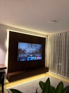 a living room with a flat screen tv on a wall at Monte Bravo Lodge in Yopal