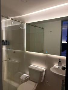 a bathroom with a toilet and a shower and a sink at Monte Bravo Lodge in Yopal