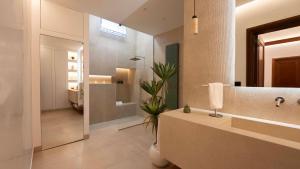 a bathroom with a sink and a toilet and a mirror at The Suite - Trani centro in Trani