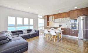 a living room with a couch and a table with chairs at Son Baulo in Can Picafort