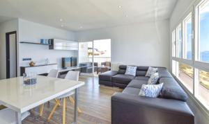 a living room with a couch and a table at Son Baulo in Can Picafort +11 photos