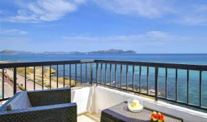 a balcony with a table and a view of the ocean at Son Baulo in Can Picafort