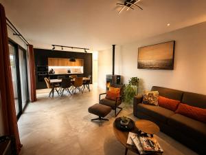 a living room with a couch and a table at Villas Vallée d'ASCO in Moltifao