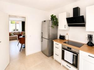 a kitchen with a stainless steel refrigerator in a room at Boutique Hotel Celler Altstadt - 24h Check-in in Celle