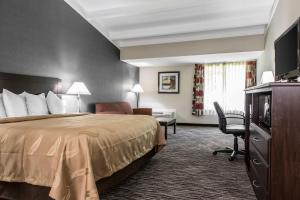 a hotel room with a bed and a television at Danbury Inn & Suites in Danbury