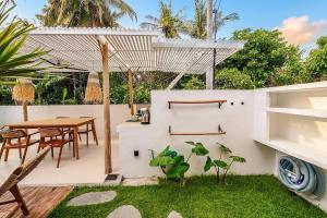a patio with a wooden table and chairs and a table at 2BR, Private Pool, Prime Location, Tropikarma in Toyapakeh