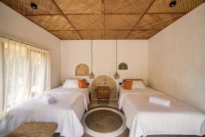 a room with three beds and a ceiling at 2BR, Private Pool, Prime Location, Tropikarma in Toyapakeh