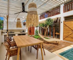 a dining room with a wooden table and chairs at 2BR, Private Pool, Prime Location, Tropikarma in Toyapakeh