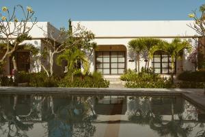 a house with a swimming pool in front of it at El Campo Mushroom in Nusa Lembongan