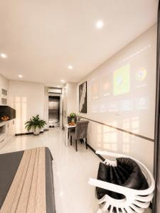 a large living room with a large screen at Sora Westlake - Modern Apartment with Balcony in Hanoi