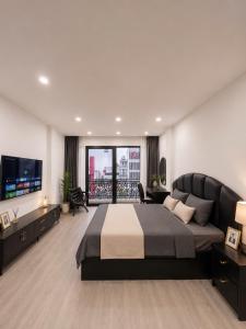 a bedroom with a large bed and a large window at Sora Westlake - Modern Apartment with Balcony in Hanoi