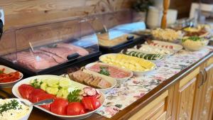 a buffet with many different types of food on a table at Willa Sulejowka in Poronin