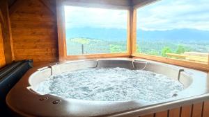 a large bath tub in a room with a window at Willa Sulejowka in Poronin +192 photos