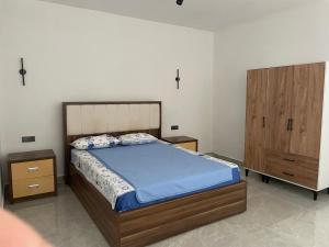 a bedroom with a bed and a wooden cabinet at Oksijen in Urla