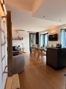 a living room with a couch and a table with chairs at Refuge d'Odeillo Vue lac Luxe 8 pers Les Angles in Réal