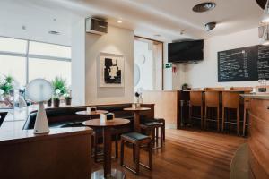 a restaurant with tables and chairs and a bar at Hotel Niza in San Sebastián +34 photos