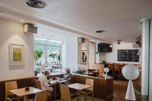 two people sitting at a table in a restaurant at Hotel Niza in San Sebastián