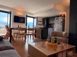 a living room with a kitchen and a dining room at Refuge d'Odeillo Vue lac Luxe 8 pers Les Angles in Réal