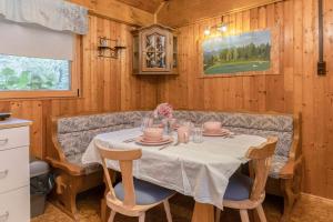 a dining room with a table and chairs at 3 Rivers Beehive cabin on a farm in Radovljica +11 photos