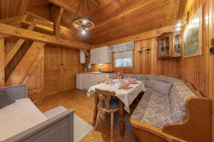 a dining room with a table and a couch in a cabin at 3 Rivers Beehive cabin on a farm in Radovljica