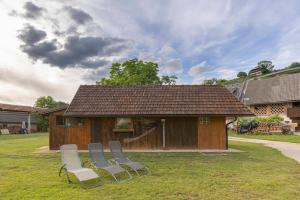 a group of chairs sitting in front of a building at 3 Rivers Beehive cabin on a farm in Radovljica